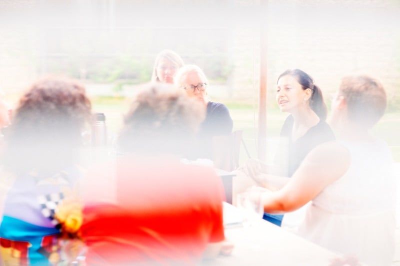 Frauen im Gespräch an einem langen Tisch bei einem GELDHELDINNEN-Treffen
